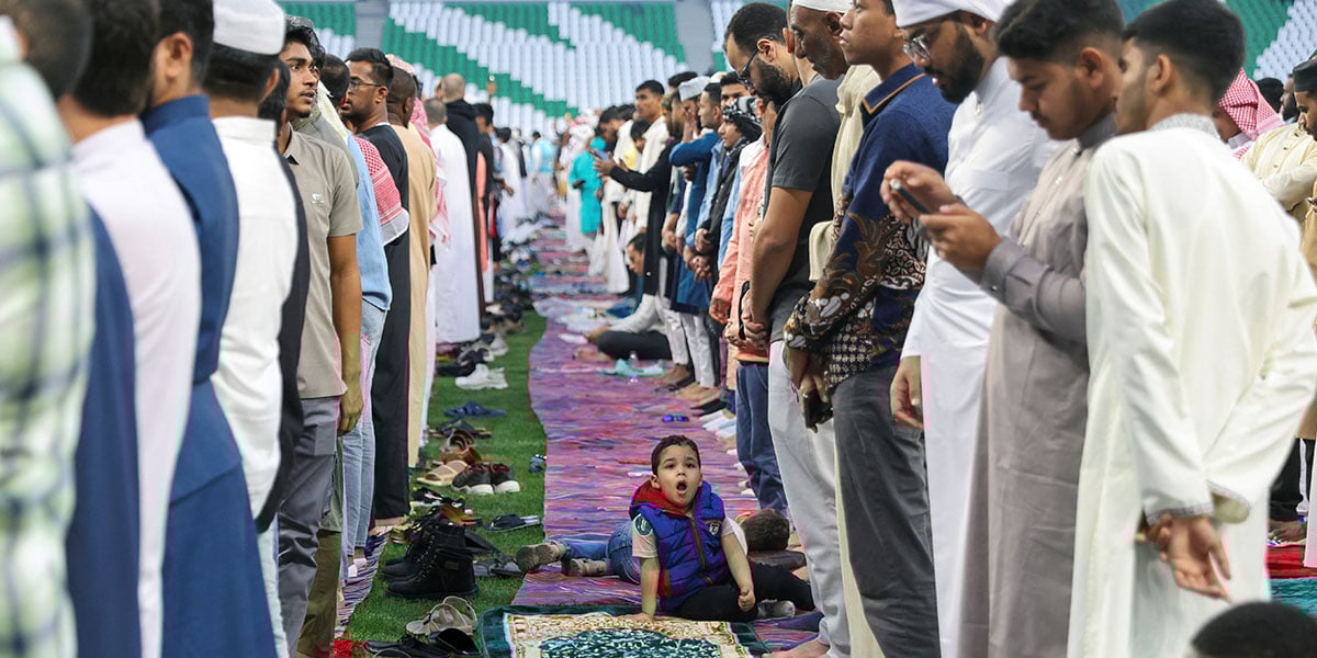 A boy yawns while Muslim worshipers attend the prayer of the UL FITR aid marking the end of the sacred fasting month of Ramadan, at the Stadium of Education, in Al Rayyan, Qatar, March 30, 2025. - Reuters