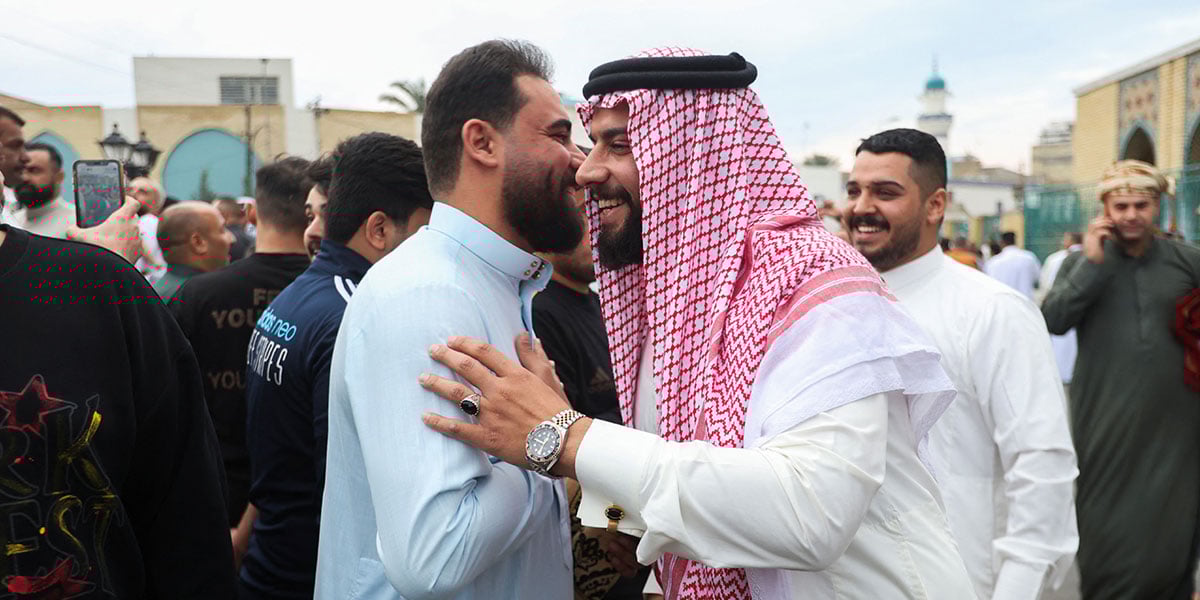 People exchange greetings after Eid prayer in a street in Baghdad, Iraq, March 30, 2025. - Reuters