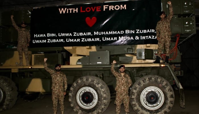 This undated image shows soldiers of the Pakistani army posing with an armed vehicle decorated with a banner featuring the names of the children martyred by Indias Cowardly Missile Strikes. - ISPR