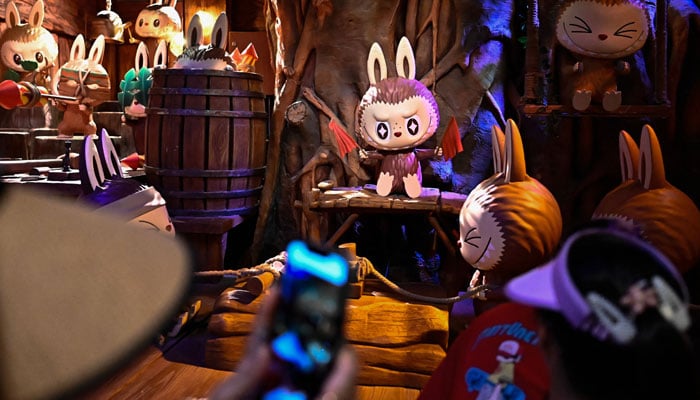 The character Labu in an exhibition hall while people visit Pop Mart Theme Pop Land in Beijing, China, June 18, 2025. - AFP