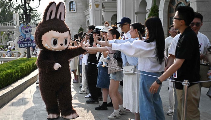 The character Labu participates in a performance in Pop Mart Theme Pop Land in Beijing, China, June 18, 2025. - AFP