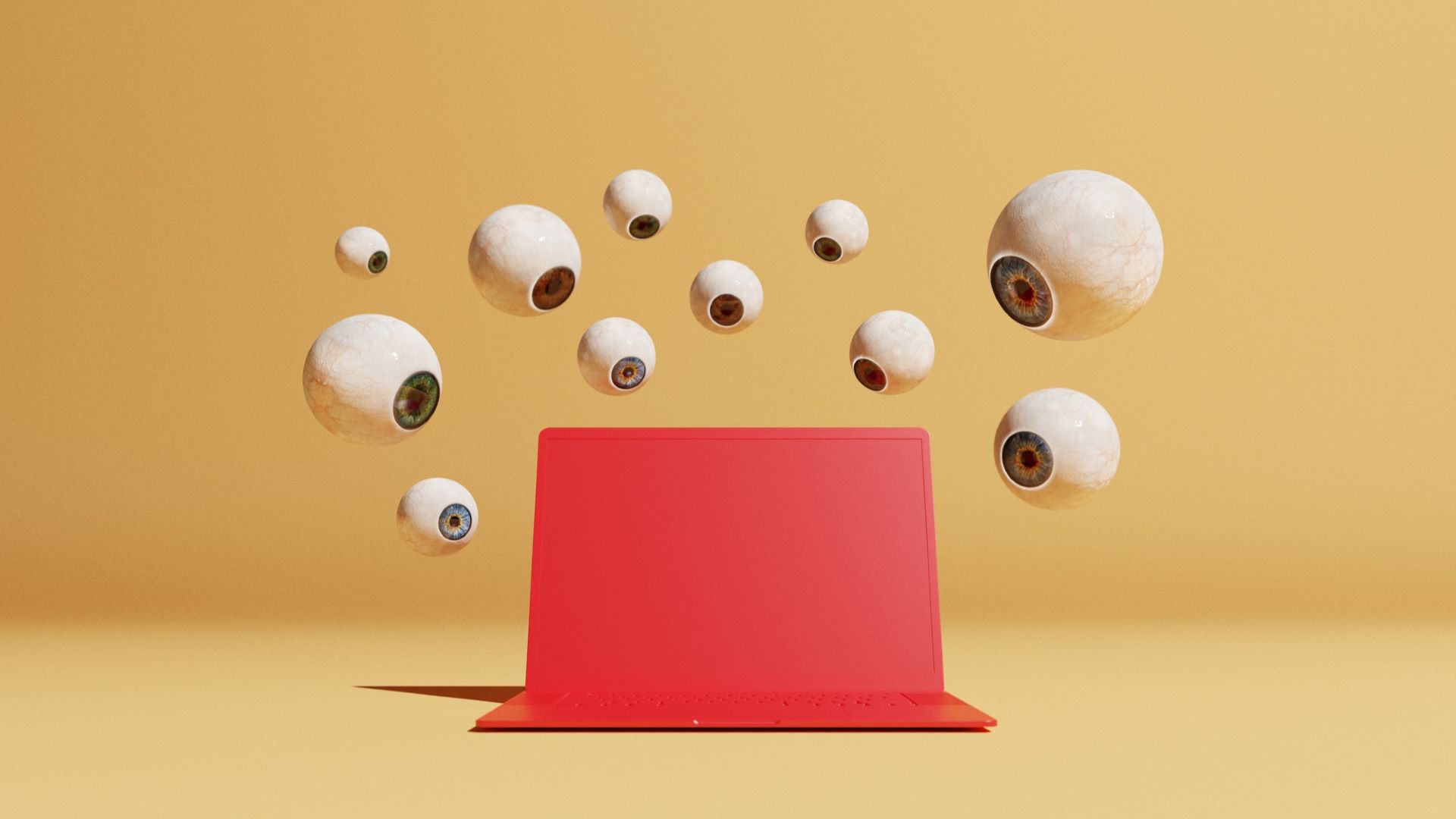The conceptual image with a bunch of floating eye globes in different sizes overlooking a red computer could symbolize ideas around malware and computer viruses