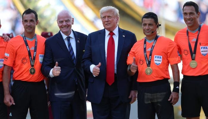 US President Donald Trump and FIFA President Gianni Infantino pose for a photo with referee Alireza Faghani and his assistant referees for the FIFA World Cup final, Metlife Stadium, East Rutherford, New Jersey, United States, July 13, 2025. - Reuters.