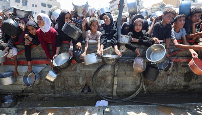The Palestinians are waiting to receive food from charity, in the middle of a hunger crisis, in Gaza City, on August 2, 2025. - Reuters