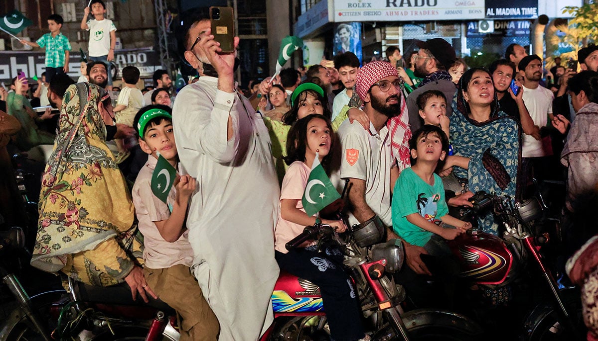 People are looking at fireworks during the celebration of independence day in Lahore on August 14, 2025. - Reuters