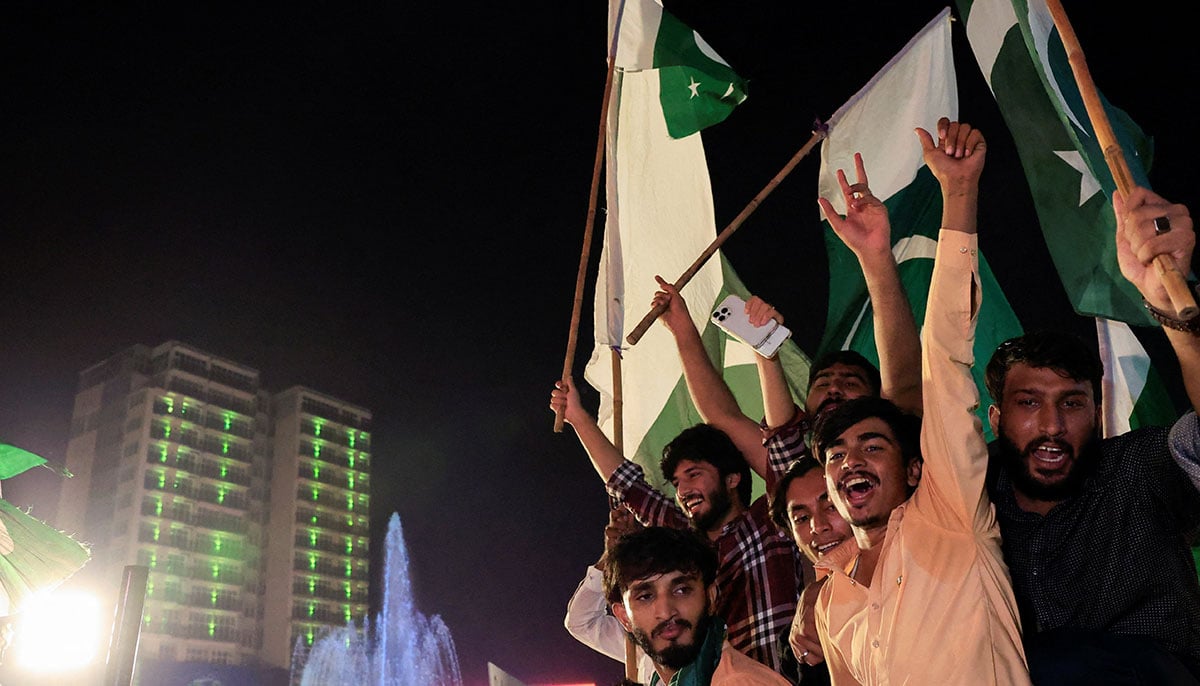 People sing slogans during the celebration of independence day in Lahore on August 14, 2025. - Reuters
