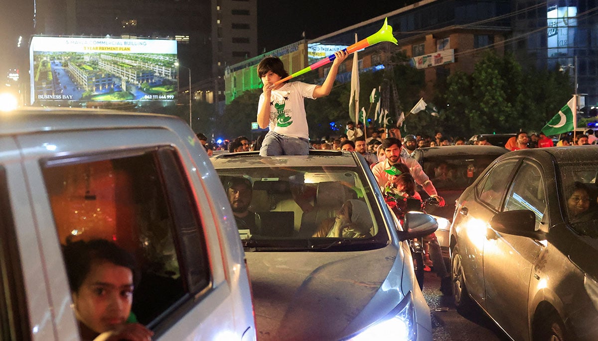 A child uses a Vuvuzela during the celebration of the day of independence in Lahore on August 14, 2025. - Reuters