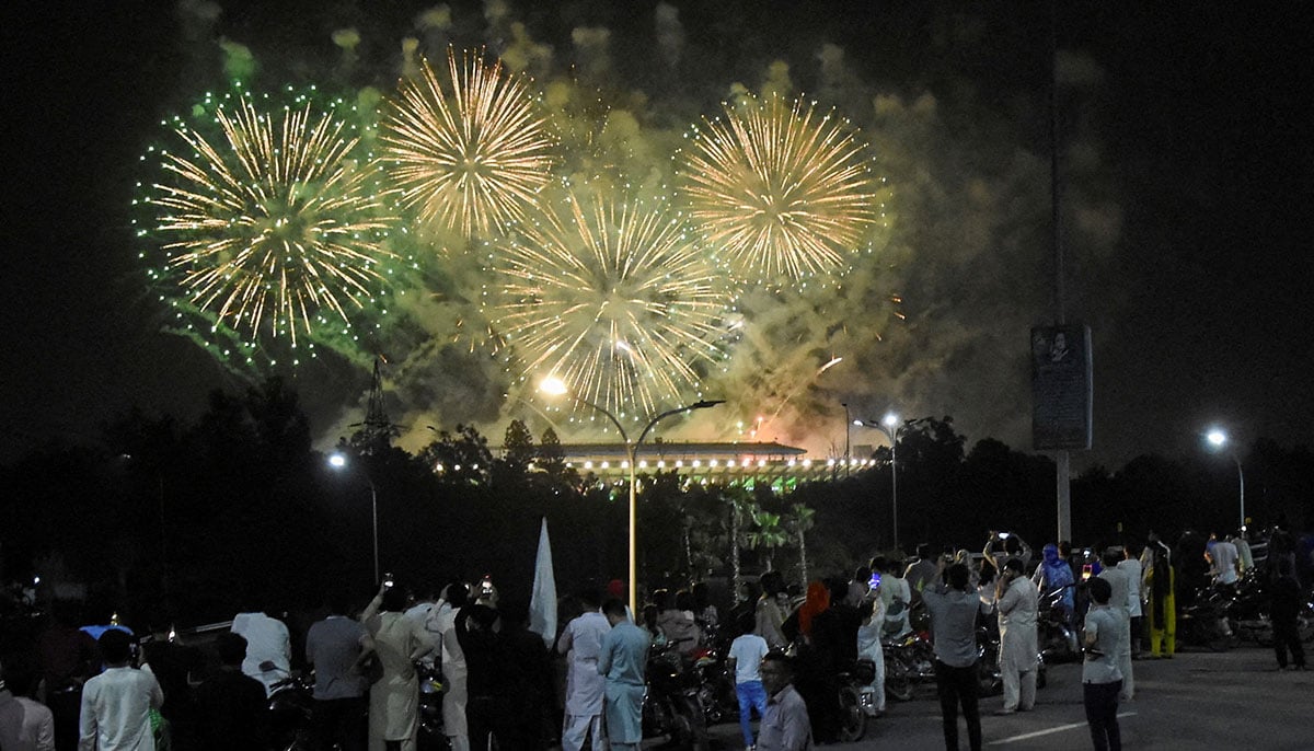 People watch fireworks explode during the celebration of independence in Islamabad on August 14, 2025. - Reuters