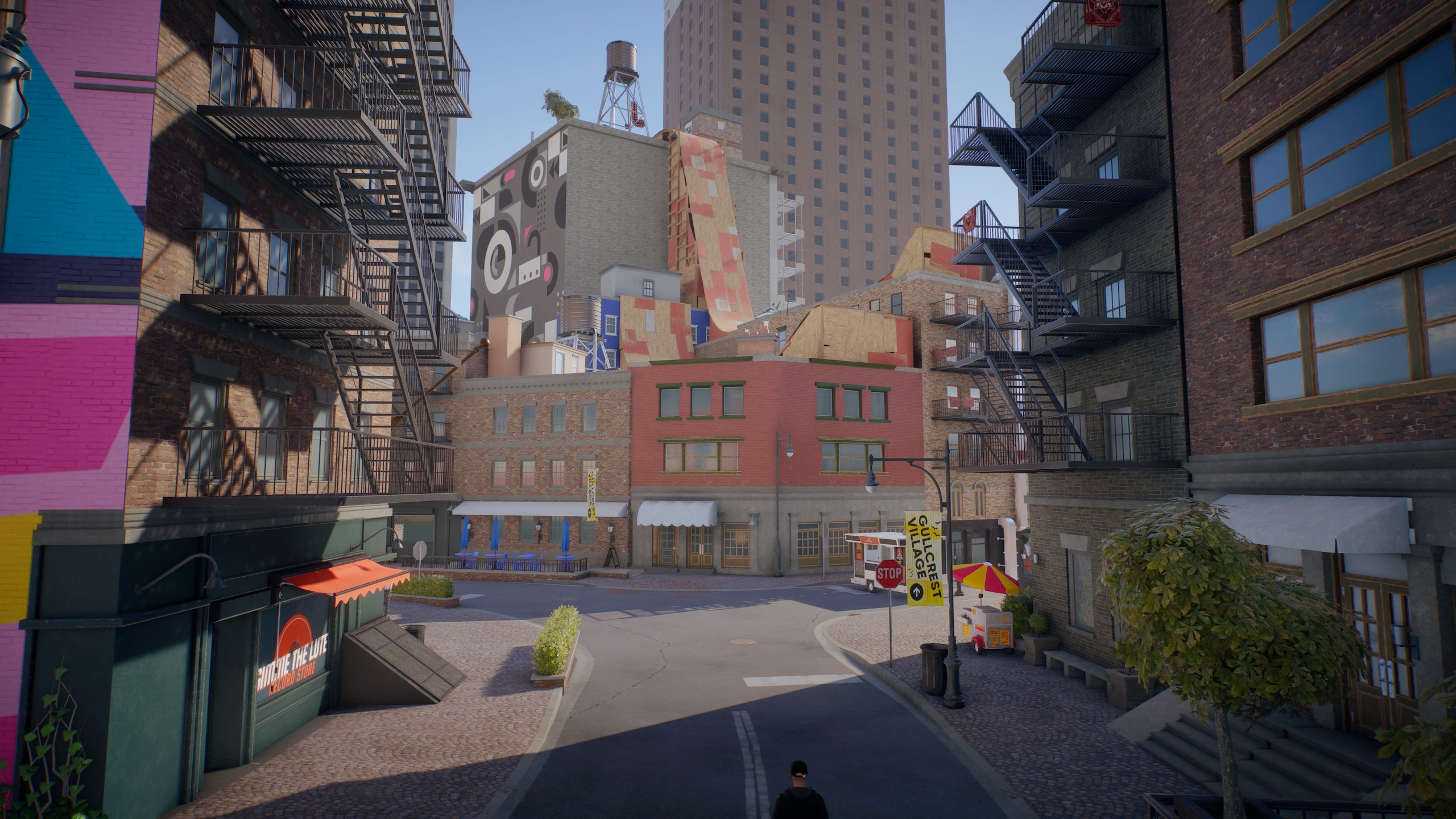 An area of ​​Sanvansterdam: colored buildings with large ramps on the roofs and a skyscraper in the distance