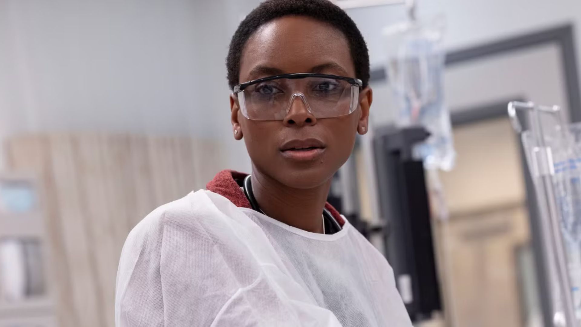Dr. Collins has surgery dresses and glasses, looking at