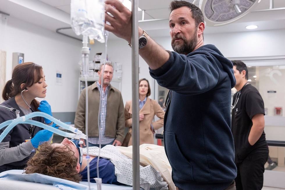 Robby checks the IV bag in the Pitt