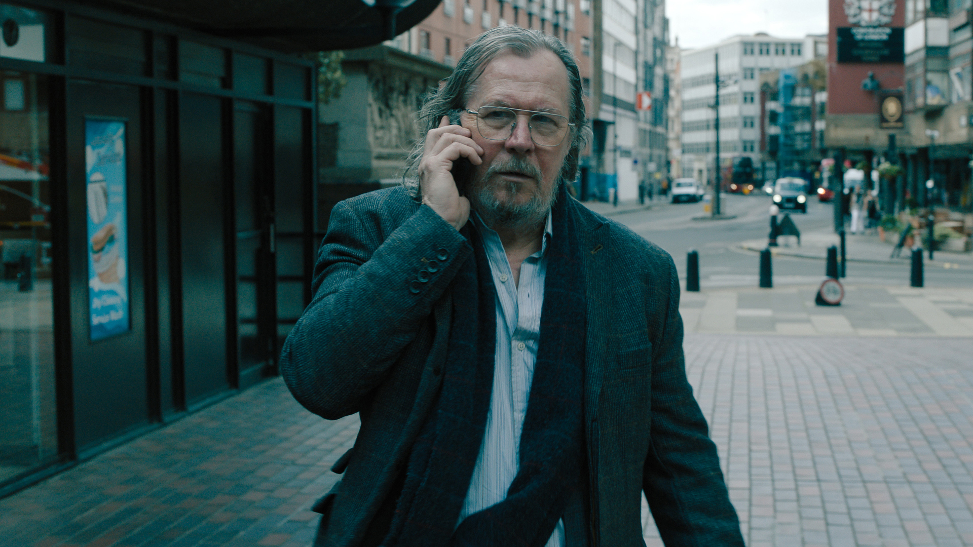 Jackson Lamb walks as he speaks on the phone in Slow Horses season 4