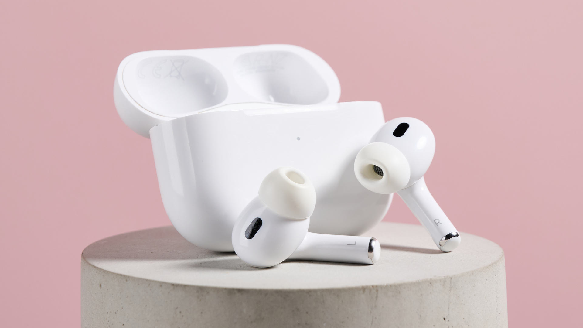 Airpods Pro 2 headphones next to their case