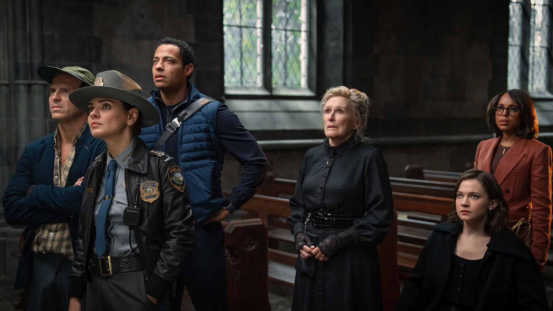 Members of the Out 3 Casts knives standing in a church