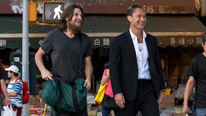 Jason Bateman and Jude Law smiling in a black rabbit