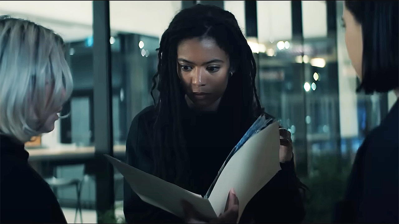 A shocked Marie looking at the Odessa project file in season 2 of season 2