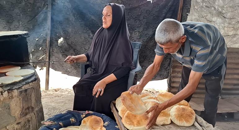 Um Mohammed Abu Zuaitter working with her husband in the oven in clay