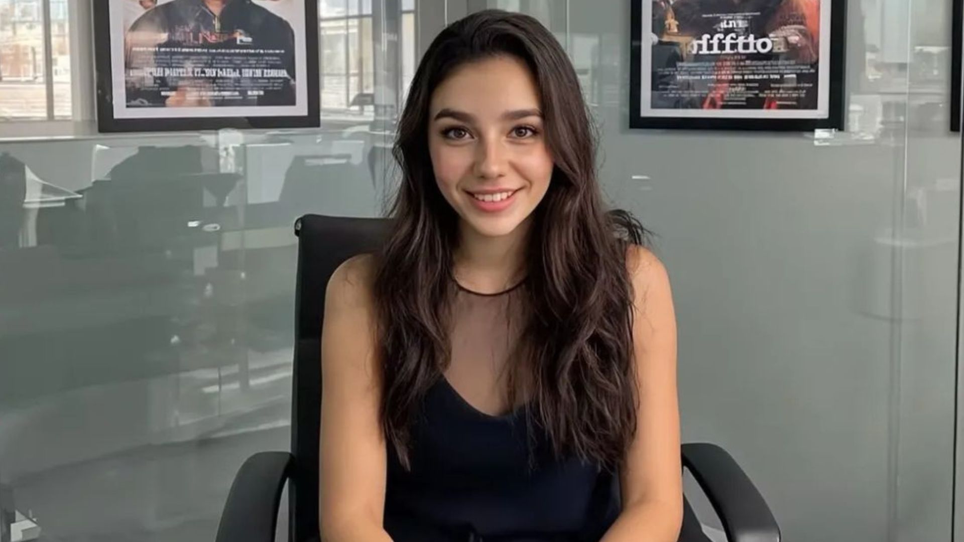 Tilly Norwood, an AI actor, is sitting in an office looking in the camera