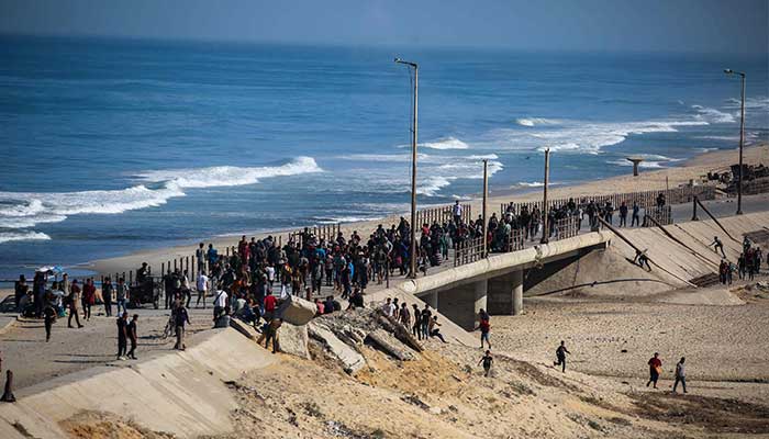 Palestinians gather on a street in Nuseirat, in the central Gaza Strip, on October 10, 2025. — AFP