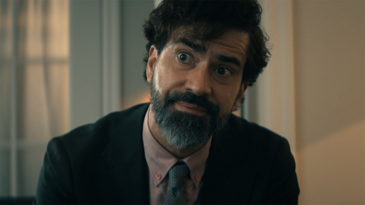 A close-up of a Cipher sitting, half-smiling, in Gen V Season 2 Episode 6.