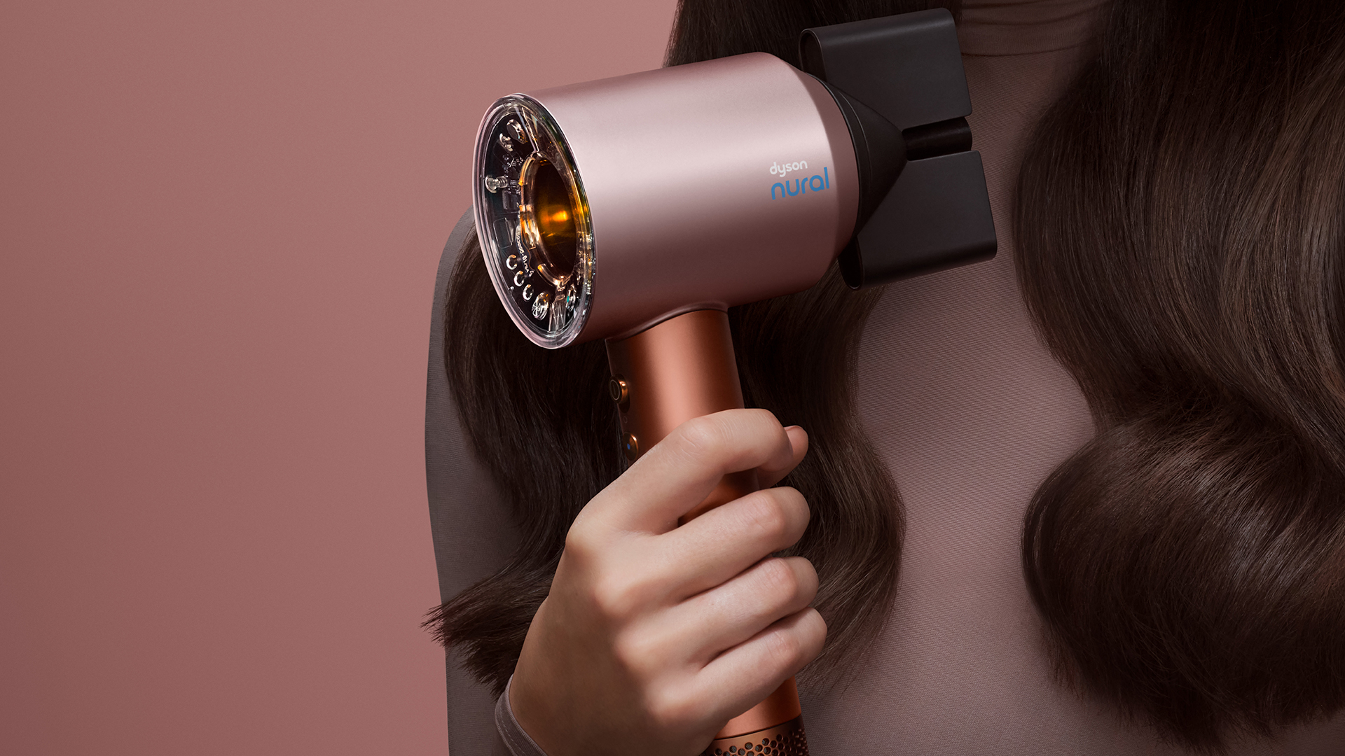 Woman using a Dyson hair tool in Amber Silk