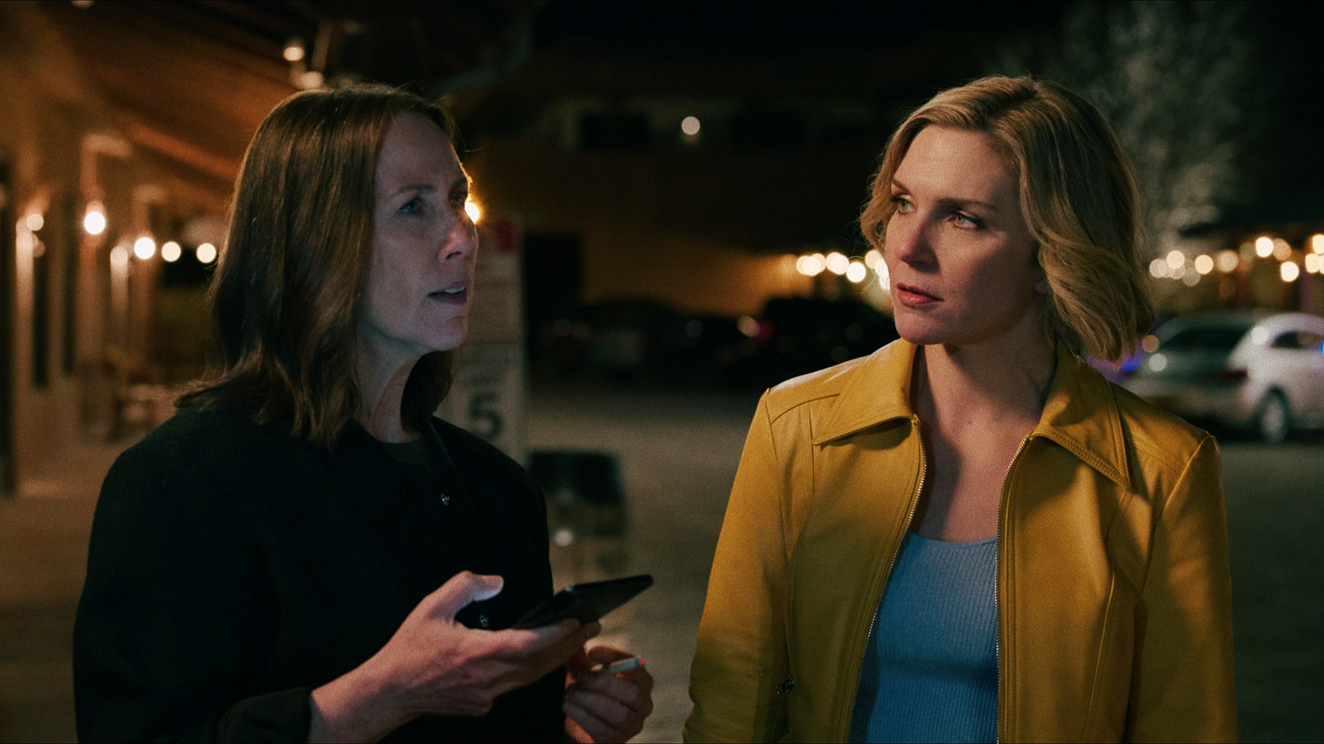 Helen holds her phone while Carol watches her in episode 1 of Pluribus