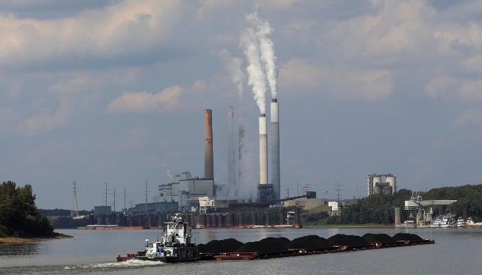 A tugboat pushes barges toward the Mill Creek Station power plant on the Ohio River in Louisville, Kentucky, the United States, September 15, 2017. — Reuters