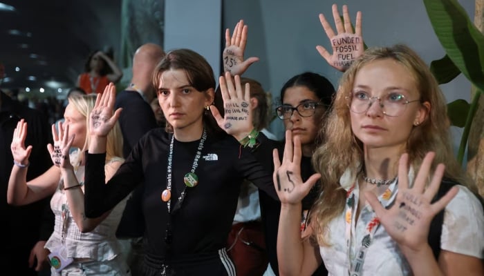 Activists show messages written on their hands as they take part in a protest as COP 30 negotiators leave the meeting room, during the United Nations Climate Change Conference (COP30), in Belém, Brazil, November 21, 2025. — Reuters