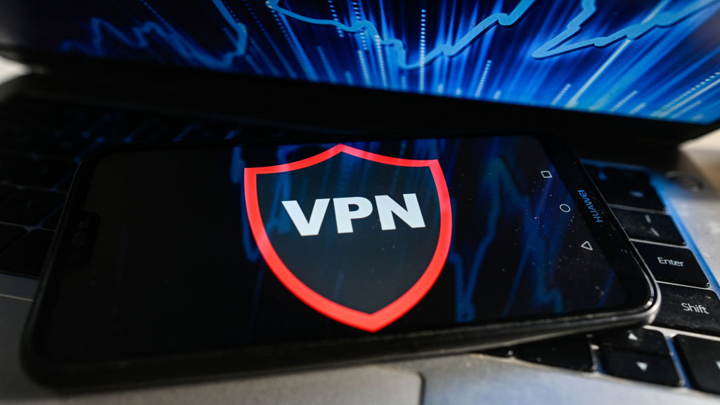 A VPN works on a mobile phone placed on a laptop keyboard