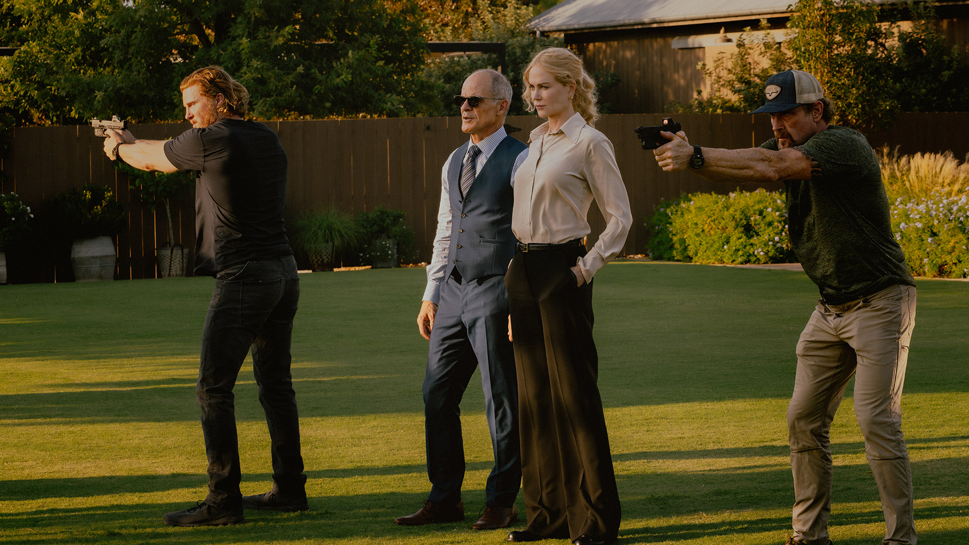 Kaitlyn and Byron stand alongside armed men in season 2 of Lioness