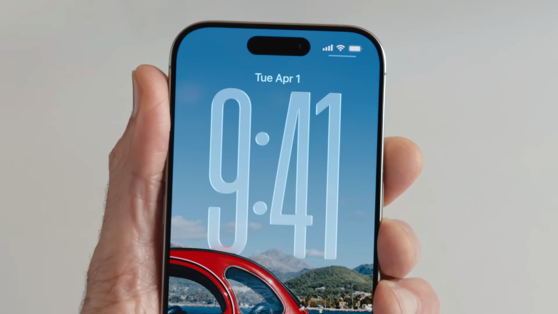The Liquid Glass clock on the iOS 26 lock screen is being demonstrated at Apple's Worldwide Developers Conference (WWDC) in June 2025.