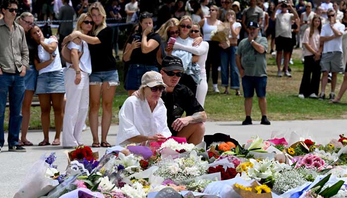 Mourners gather for floral tributes at Bondi Pavillion in memory of the victims of a shooting at Bondi Beach, Sydney, December 15, 2025. — AFP
