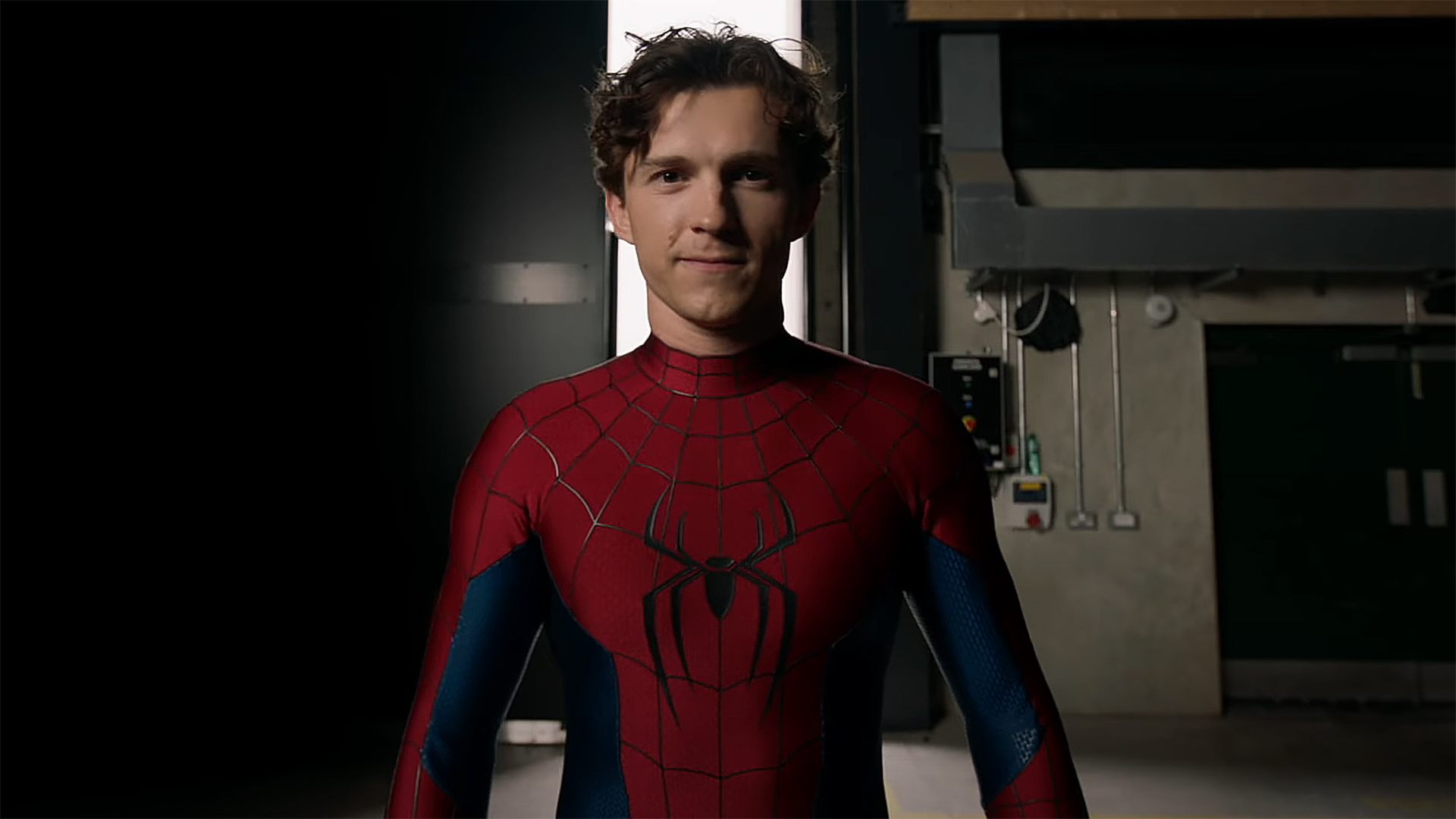 Tom Holland wearing his new Spider-Man costume and smiling in a behind-the-scenes video from Spider-Man: Brand New Day