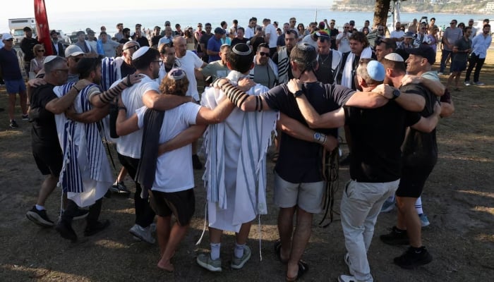 Members of the Jewish community gather for Shacharit, the morning prayer, as the crime scene was reopened after the mass shooting at Bondi Beach on Sunday, in Sydney, Australia, December 19, 2025. — Reuters