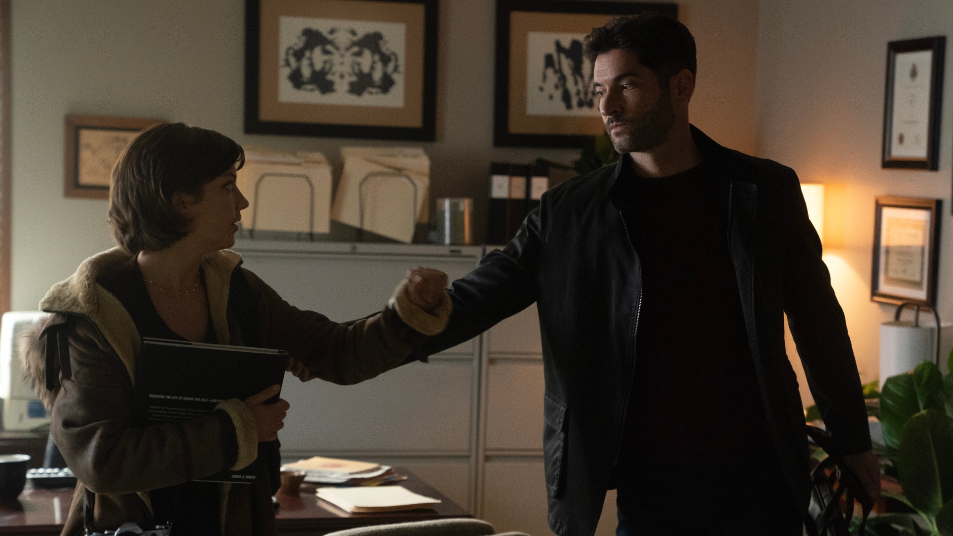 Oliver holds Bree's arm in season 3 of Tell Me Lies