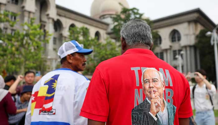 A supporter wears a shirt with the portrait of former Malaysian Prime Minister Najib Razaks printed on it, outside the courthouse in Putrajaya, Malaysia, December 26, 2025. — Reuters