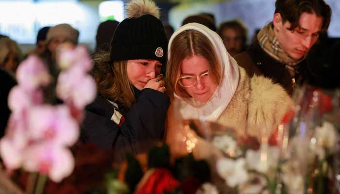 People react outside the Le Constellation bar, after a fire and explosion during a New Year's Eve party in the upscale ski resort of Crans-Montana, southwest Switzerland, January 1, 2026. — Reuters