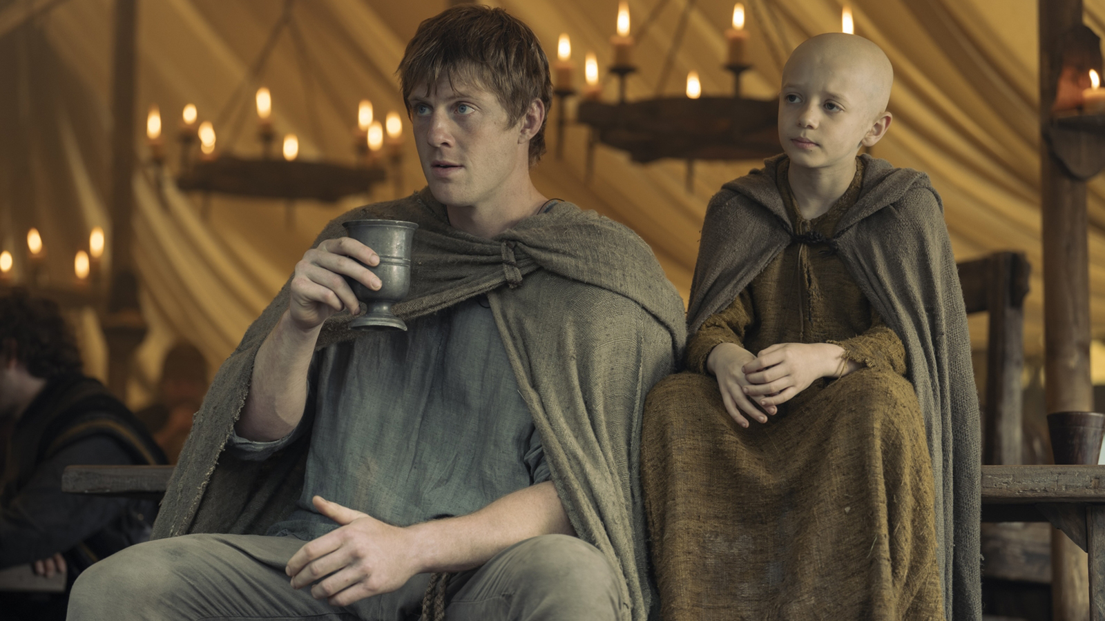 Duncan holding a cup as 'Egg' sits next to him in Season 1 of The Knight of the Seven Kingdoms