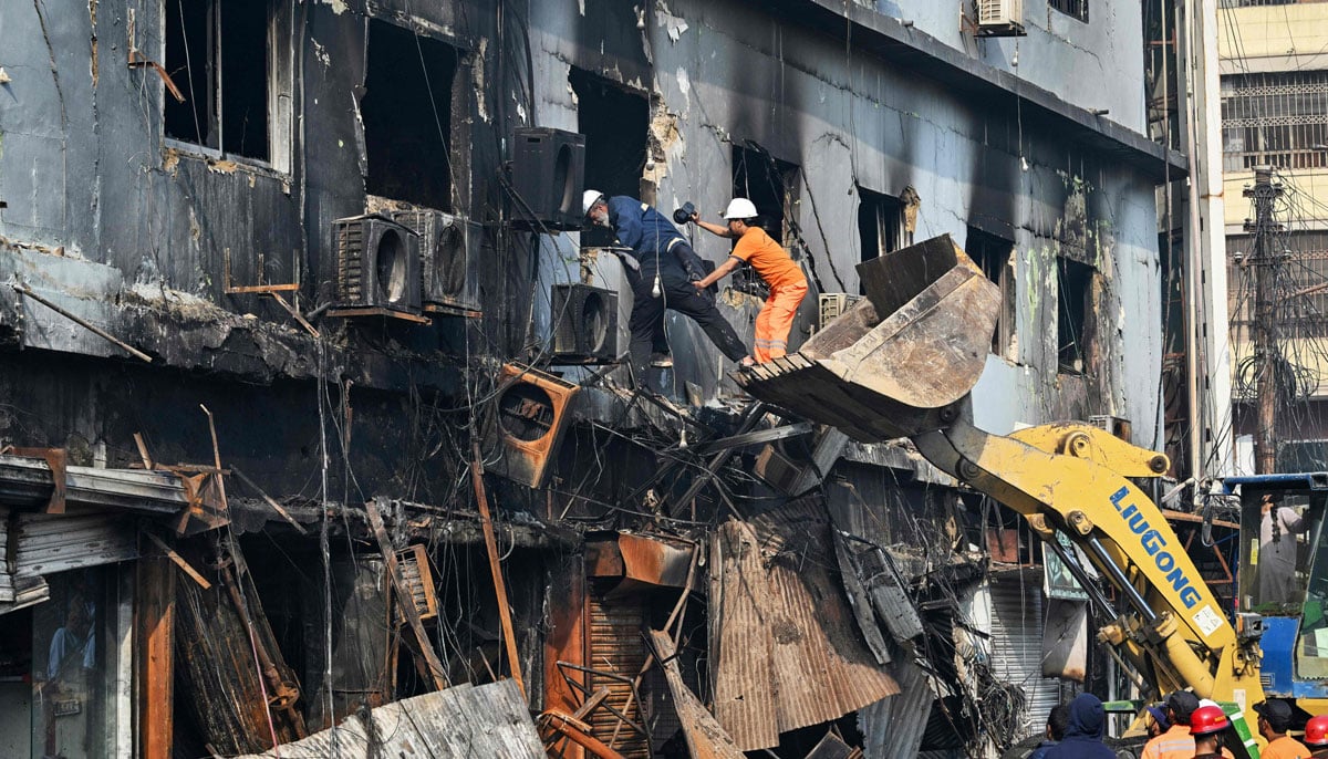 Rescuers search a burned structure after a massive fire at a shopping mall in Karachi, January 19, 2026. — AFP
