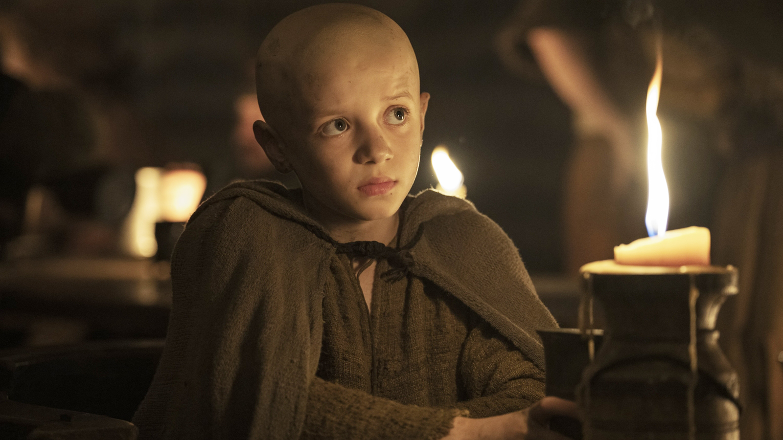 Egg sitting in a dark tent next to a lit candle in episode 2 of The Knight of the Seven Kingdoms