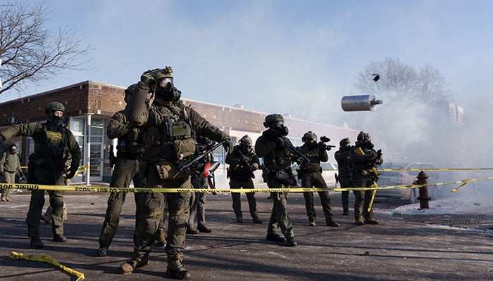 A federal agent throws a tear gas canister near the site where a man identified as Alex Pretti was fatally shot by federal agents trying to arrest him, in Minneapolis, Minnesota, United States, January 24, 2026. — AFP