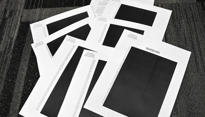 Documents redacted after the U.S. Department of Justice began releasing long-awaited documents from the investigation into the politically explosive case of convicted sex offender Jeffrey Epstein. -AFP