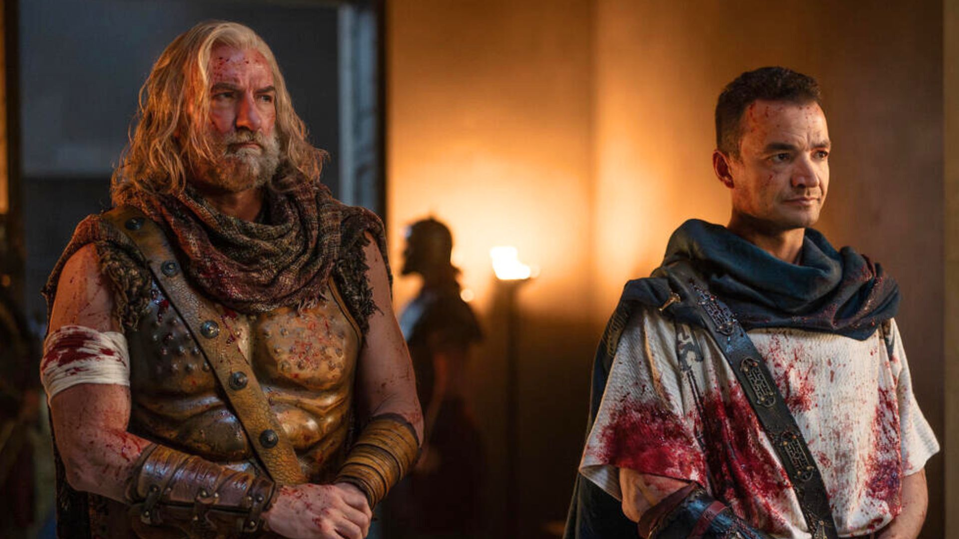 Korris and Ashur stand side by side covered in blood
