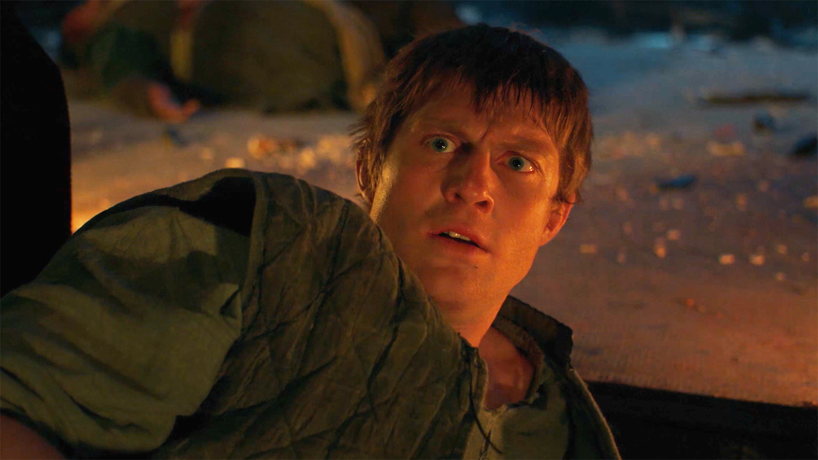 A perplexed Dunk lying on the ground and looking at an egg off-camera in episode 3 of A Knight of the Seven Kingdoms