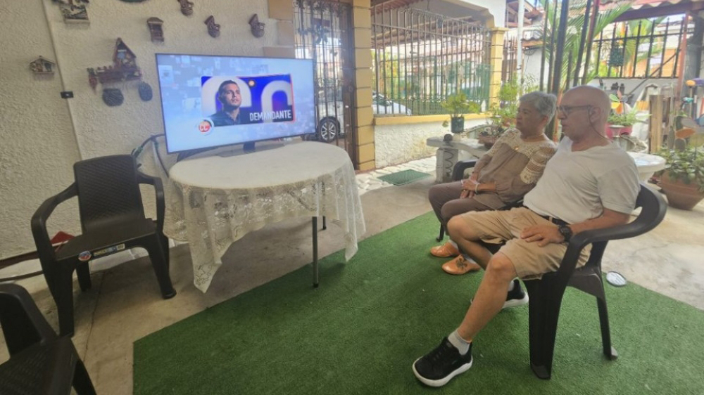 A couple watching a Samsung flat screen TV