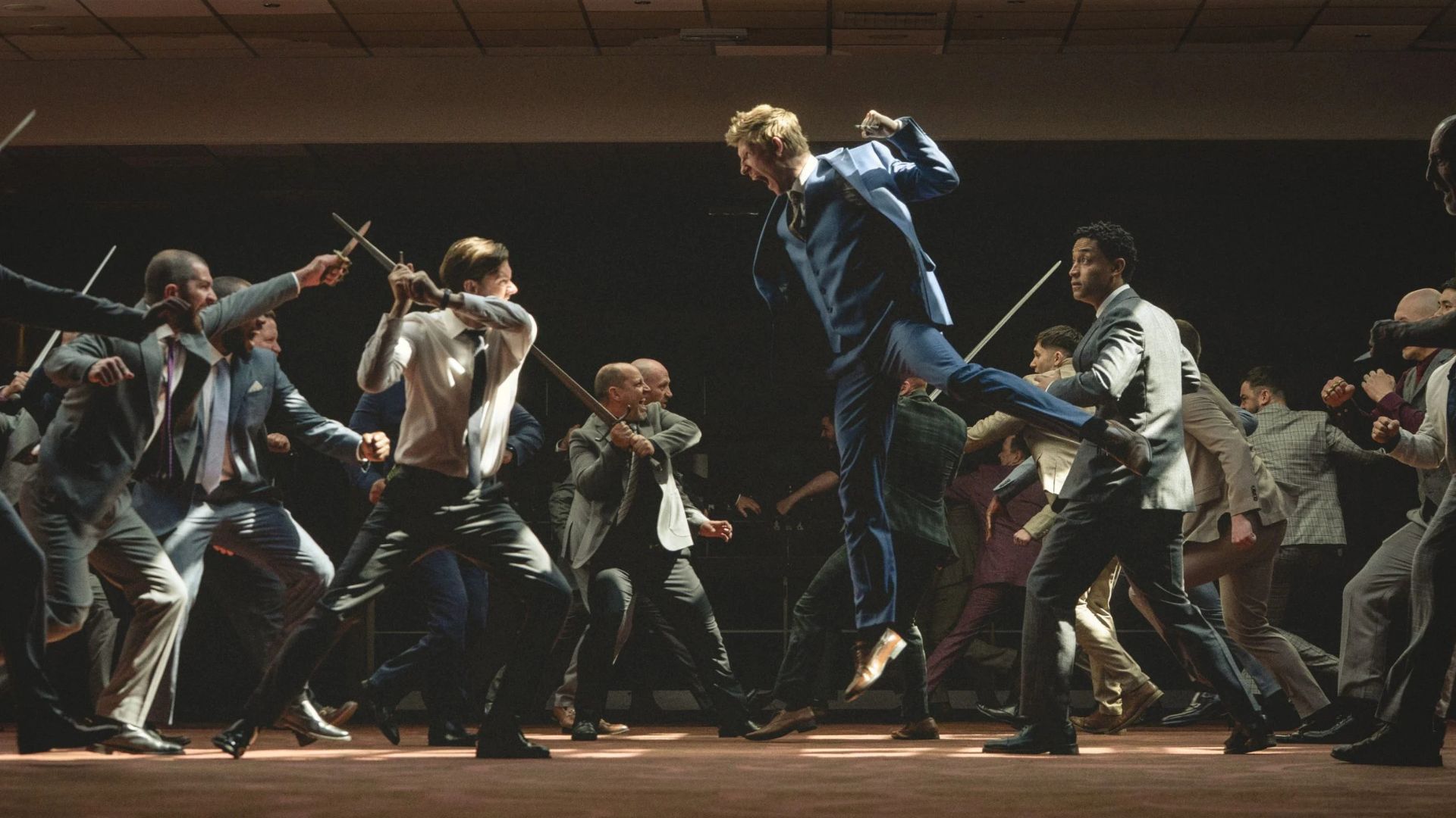 Two groups of boys throw swords at each other