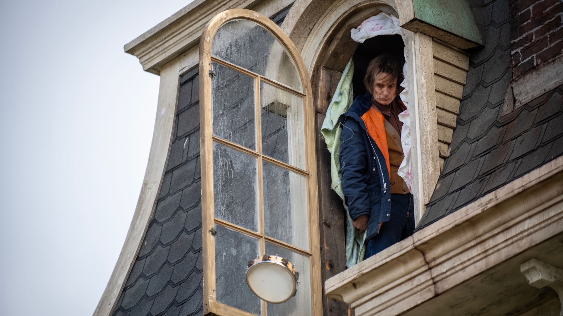Victor stands at a window in season 3
