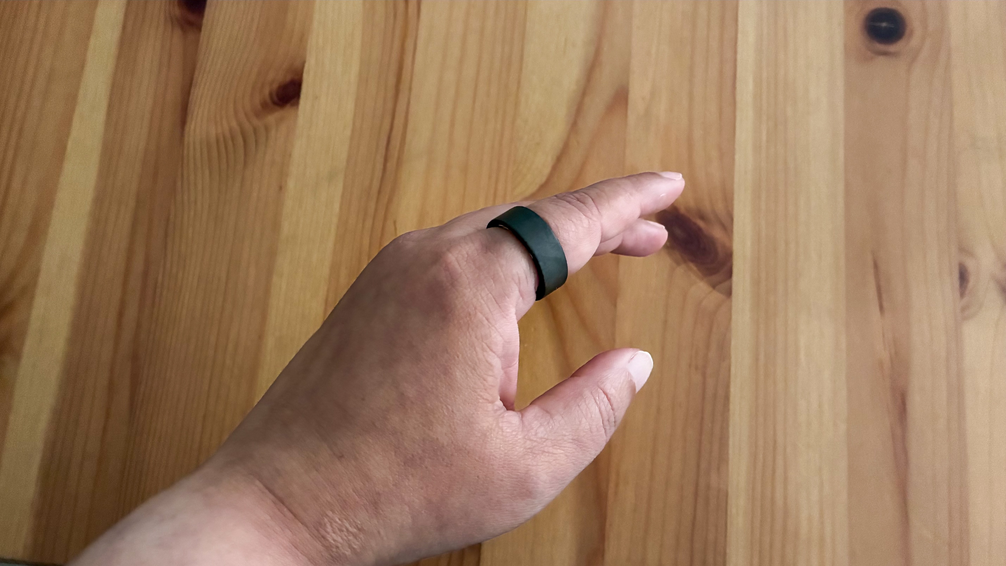 The Ultrahuman Ring Air on an index finger