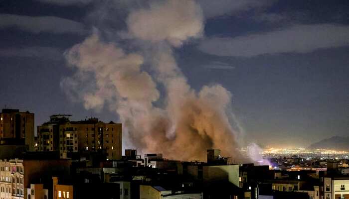 A plume of smoke rises following a missile strike on a building in Tehran, March 1, 2026. — AFP