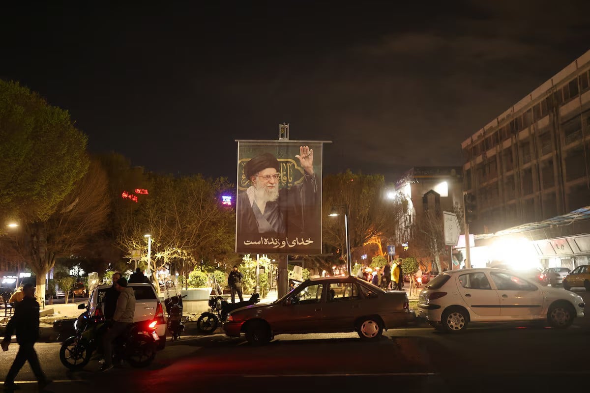 A banner of Iranian Supreme Leader Ayatollah Ali Khamenei on a street after his death in Israeli and U.S. strikes on Saturday, in Tehran, Iran, March 1, 2026. — Reuters